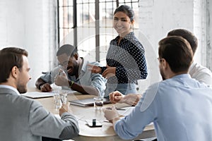 Diverse millennial business team with Indian leader discussing project