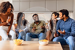 Diverse millennials friends come together for joyous party indoors