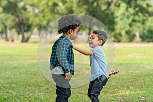 Diverse mixed race kids as friends have fun playing together in park in summer