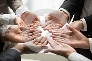 Diverse multi-ethnic business team members join hands together p photo