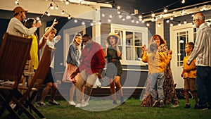 Diverse Multicultural Friends and Family Dancing Together at an Outdoors Garden Party Celebration