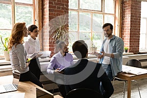 Diverse multiethnic colleagues engaged in team discussion at meeting