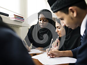 Diverse Muslim children studying in classroom photo