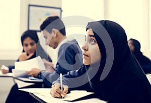 Diverse Muslim children studying in classroom photo