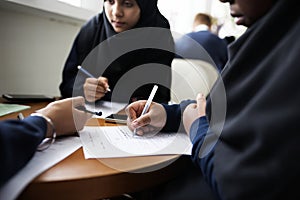 Diverse Muslim girls studying in a classroom photo