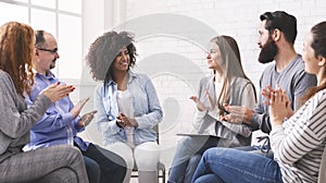 Diverse people applauding to themselves at therapy session in rehab