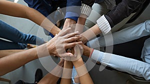 Diverse people business partners friends colleagues stacking palms in pile