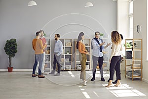 Diverse people communicating at business networking event in modern office workspace