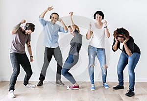 Diverse people dancing together listening to music