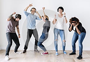 Diverse people dancing together listening to music photo