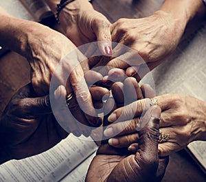 Diverse people holding hands religious concept photo