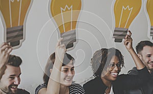 Diverse People holding lightbulb icons