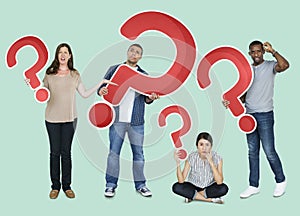 Diverse people holding question mark icons