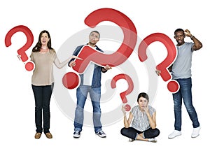 Diverse people holding question mark icons