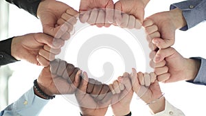 Diverse people holding their fists together in the office