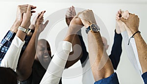 Diverse people joining hands together success and celebration concept