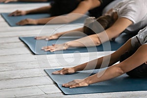 Diverse people practicing yoga close up, doing Child exercise photo