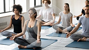 Diverse people practicing yoga, sitting in Easy Seat pose