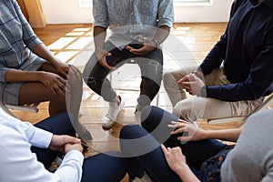 Diverse people during psychological rehab session sitting indoors