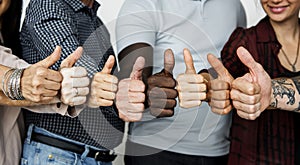 Diverse people showing up thumbs