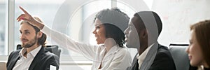 African woman raise hand ask question during seminar at boardroom photo