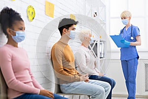 Diverse People Sitting Waiting For Doctor`s Appointment In Hospital