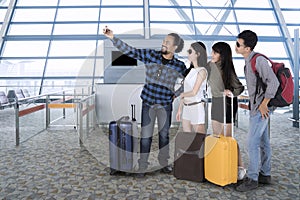 Diverse people taking a picture in the airport