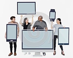 Diverse people with various mockup of digital devices