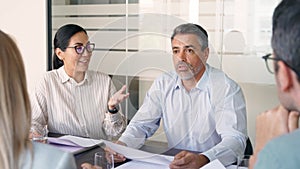 Diverse professional executive team people working at board meeting in office.