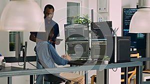 Diverse programmers collaborating on coding project compiling algorithm