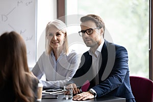 Diverse recruiter talk with business partner at office meeting