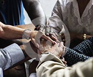 Diverse religious people joining hands