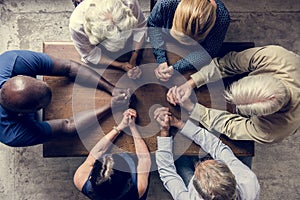 Diverse religious people praying together