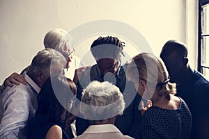 Diverse religious people praying together