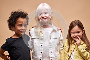 Diverse smiling positive children posing at camera