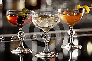 Elegant stemware presents a variety of cocktails with garnishes on a bar photo