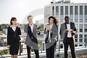 Diverse specialists taking coffee break on fresh air