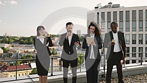 Diverse specialists taking coffee break on fresh air