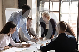 Diverse staff engaged at financial stats information analysis at meeting