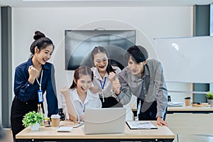 Diverse startup young people and partnership celebrate while successful project at meeting room