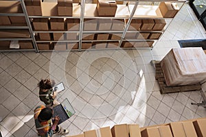 Diverse storage room workers tracking customers orders