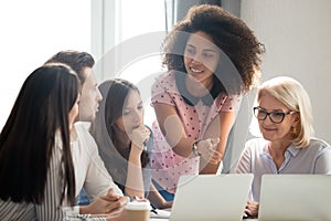 Diverse students workers team and mentor teacher involved in discussion