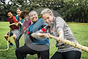 Diverse team competing in tug of war