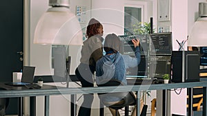Diverse team of database admins analyzing source code and comparing data script