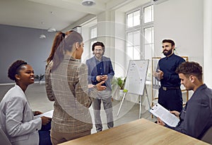 Diverse team of happy business people talking during a work meeting in the office