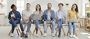 DIverse team of happy, cheerful company people having fun at casual meeting at work