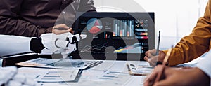 Diverse team holding discussion about data analysis with artificial intelligence, charts, graphs, and reports in modern