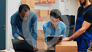 Diverse team of people checking supply chain on warehouse shelves