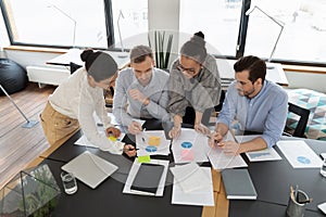 Diverse team of professionals analyzing marketing research