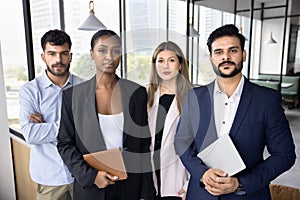 Diverse team of serious confident business colleagues wearing formal suits